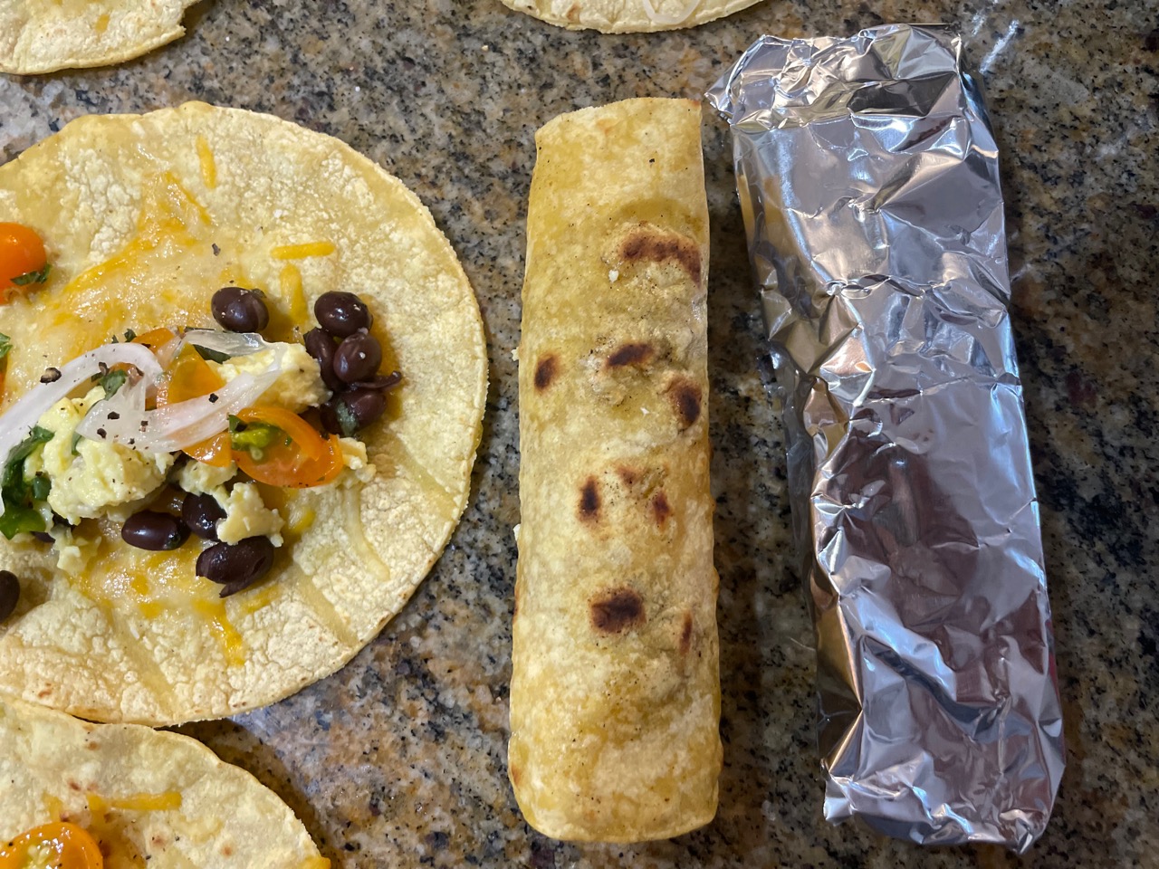 a rolled taquito next to one rolled in foil